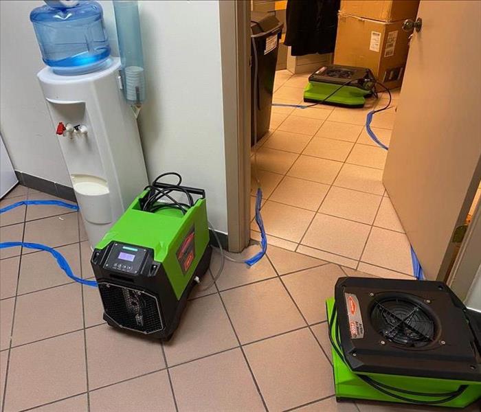 Three air movers on a tile floor. 