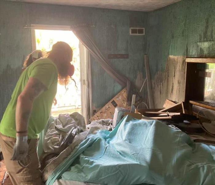 Team members inside of fire damaged home.